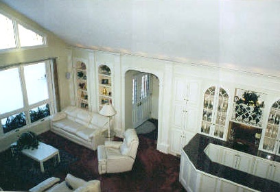 White painted built-in bookcases, cabinets and a glazed display unit in a living room
