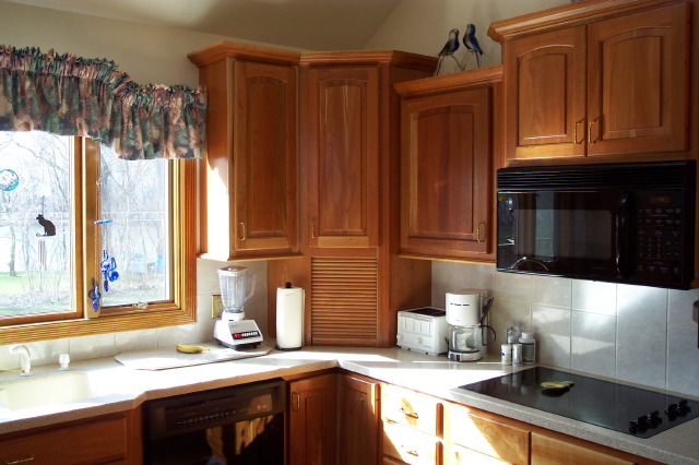 Cherry wall cabinets and a corner appliance garage in a Kitchen-Works kitchen