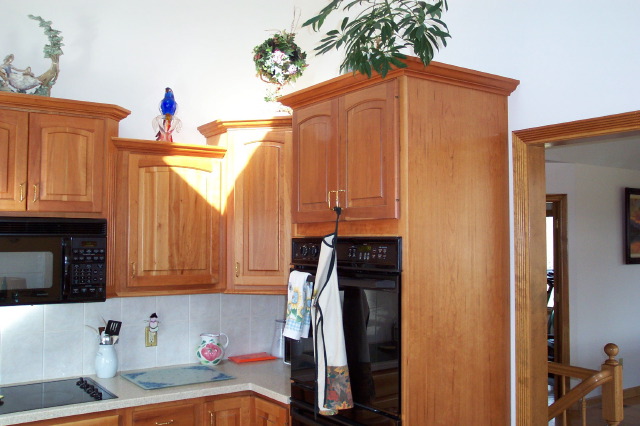 Cherry cabinetry framing a built-in wall oven and microwave
